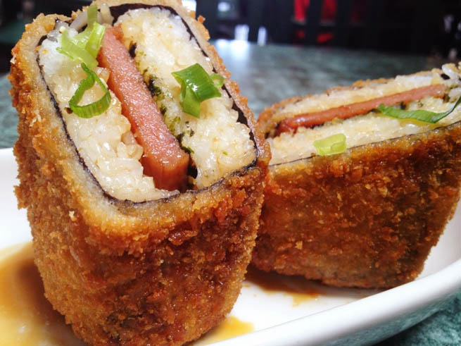 Spam musubi is a popular snack and lunch food in Hawaii composed of a slice of grilled Spam on top of a block of rice, wrapped together with nori dried seaweed CT