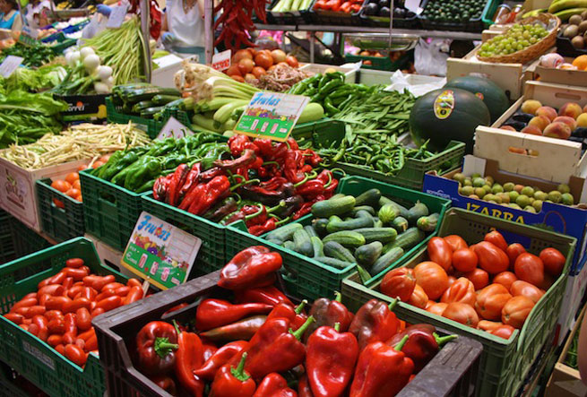 Colorful vegetables line the markets in Spain. Find out where to shop in Spain, including ideas for Madrid, Barcelona, Seville and Bilbao.