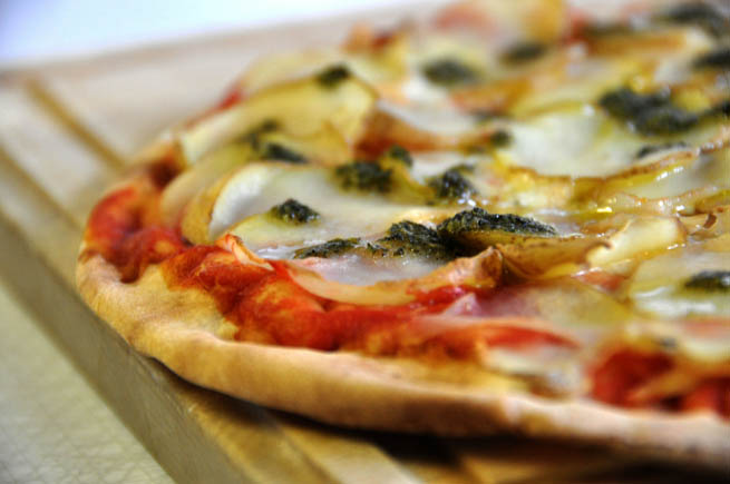 Pizza is an oven-baked flat bread typically topped with tomato sauce and cheese.